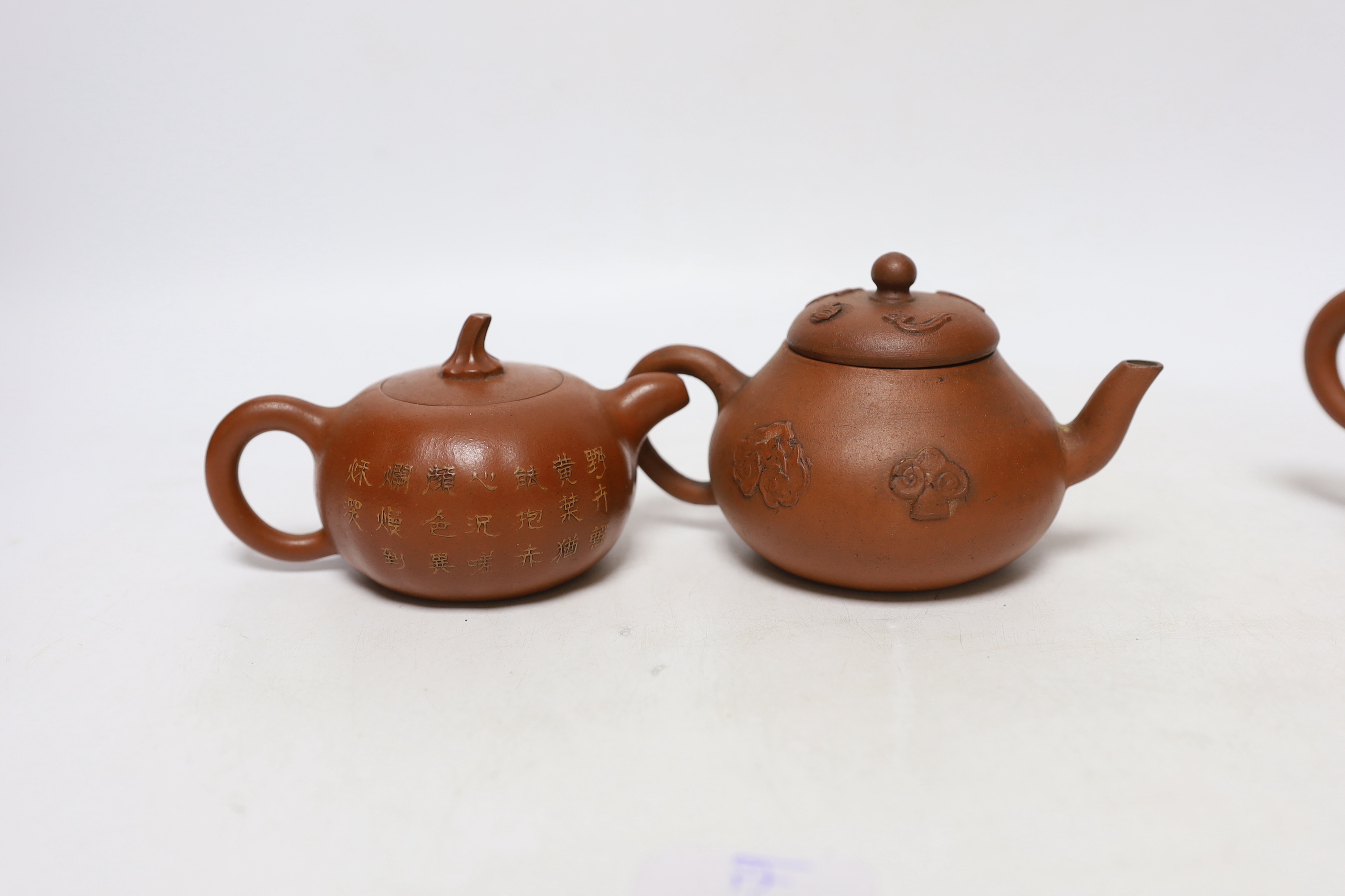 Four Chinese Yixing teapots, one slip decorated with a landscape, tallest 10.5cm